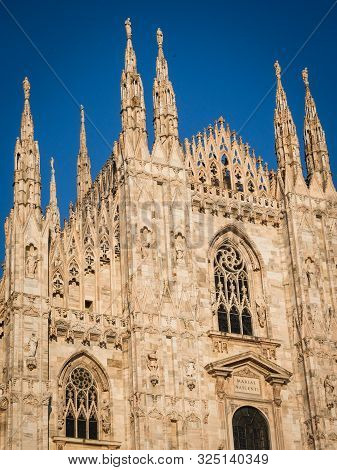 Ornate Facade Of Milan Catehdral In Italy At Sunset