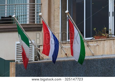 Italy Netherlands Hungary Flags Hang On A Wall In Malta