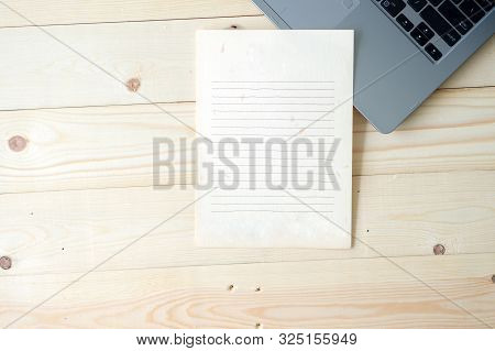 A Laptop On The Dask Wood Material