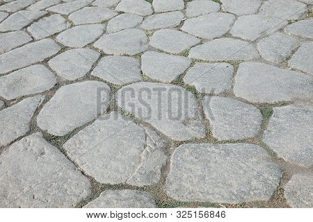 Background Of Old Huge Stones Of An Ancient Roman Road In Southern Italy