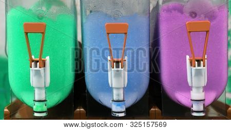 Dispenser Of Shave Ice With Colored Syrup Called Grattachecca In Italian Language
