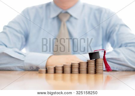 A Businessman Saveing Coin For Eudcation Concept