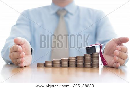 A Businessman Saveing Coin For Eudcation Concept