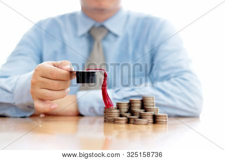 A Businessman Saveing Coin For Eudcation Concept