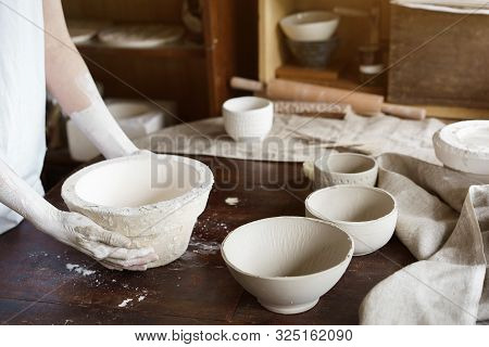 Female Hands Hold A Bowl For Casting Clay Products