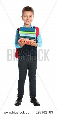 Happy Boy In School Uniform With Stack Of Books On White Background
