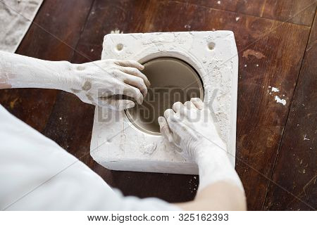Female Hands Hold A Bowl For Casting Clay Products.