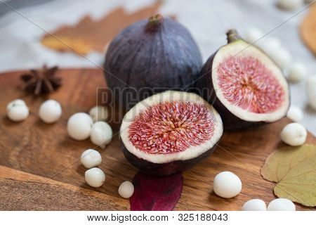 Cut Fresh Tasty Ripe Figs On Desk With White Snow Berry, Anise, Fallen Dry Leaves, Soft Focus. Figs 