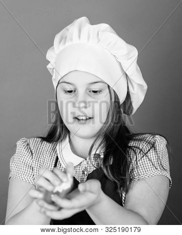 When Kneading Is A Pleasure. Adorable Little Girl Kneading Dough In Hands. Small Child Kneading Swee