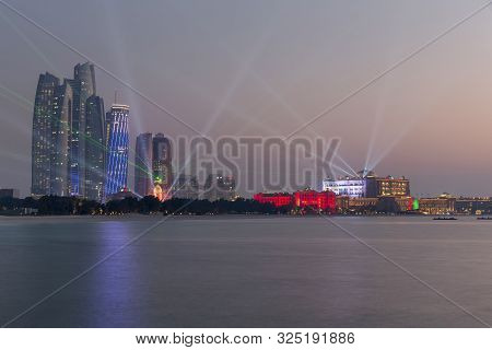 Abu Dhabi, Uae - December 1, 2017: Abu Dhabi Skyline With Emirates Palace And Etihad Towers Lit Up F