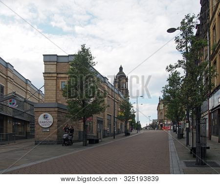 Bradford, West Yorkshire, United Kingdom - 19th June 2019: People Walking In The Street In The Rawso