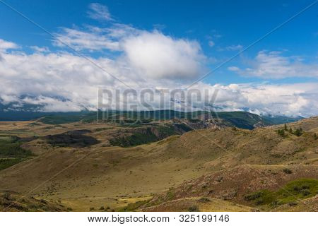 Summer in Kurai steppe and North-Chui ridge of Altai mountains, Russia. Cloud day.