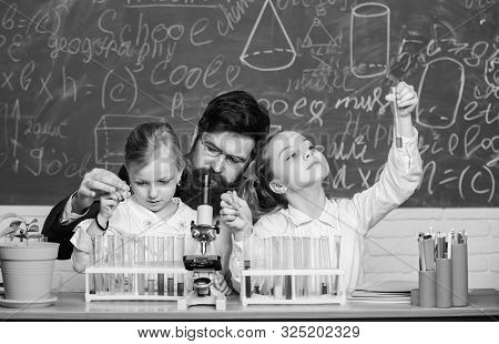 Prove It. Little Girls Performing Experiment Under Teacher Supervision. Small School Children Holdin