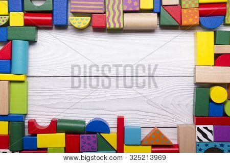 Colorful Kids Toys Frame On Wooden Background. Top View. Flat Lay. Copy Space For Text.