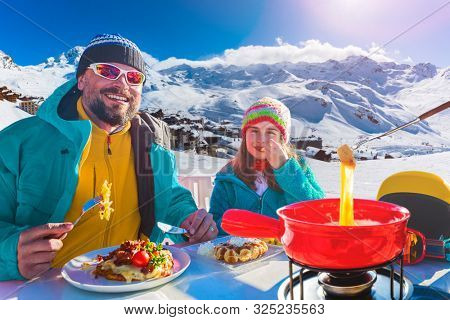 Ski restaurant lunch break with Fondue cheese, mountain view of Val Thorens, 3 valleys , France.