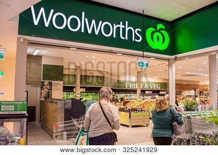 Sydney, Australia 08-31-2019: Entrance And Exterior View Of Woolworths Supermarket. Two Female Custo