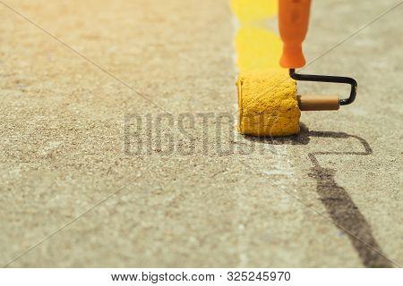 Male Students Use Small Paint Rollers To Paint Yellow Lines On The Cement Floor For Sepak Takraw Tra