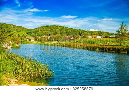 Croatia, Countryside Rural Landscape, Village By Gacka River In Region Of Lika