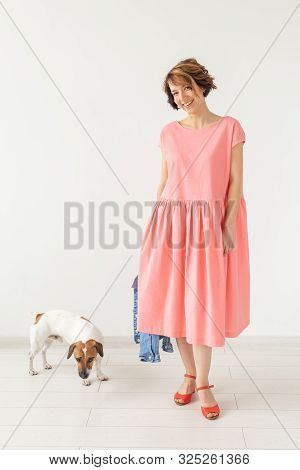 Pets Owner Concept - Young Woman In Pink Dress With Jack Russell Terrier Dog Over The White Backgrou