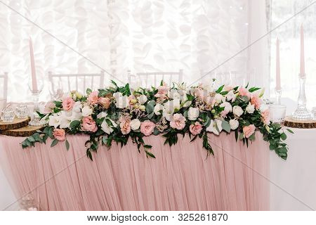 Luxurious And Large Composition Of Fresh Flowers. Pink And White Eustoma On The Wedding Table.