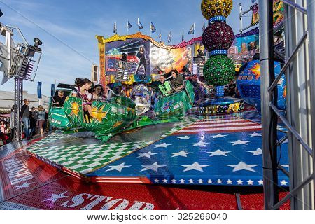 Munich, Germany, 2019 September 28: Visitors Enjoy On An Amusement Park Ride. Breakdancer Fun Ride, 