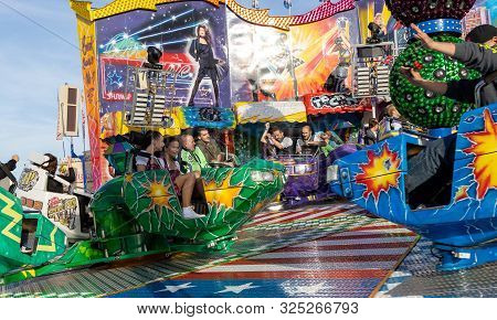 Munich, Germany, 2019 September 28: Visitors Enjoy On An Amusement Park Ride. Breakdancer Fun Ride, 