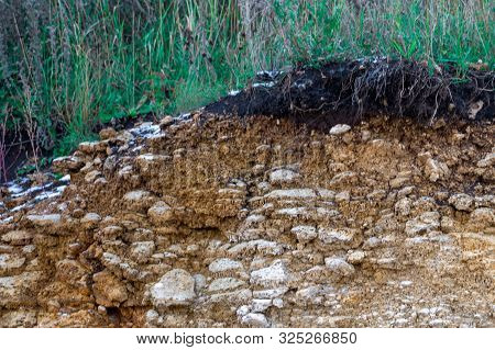 The Curb Erosion From Storms. To Indicate The Layers Of Soil And Rock. Nature Cross Section Soil Und