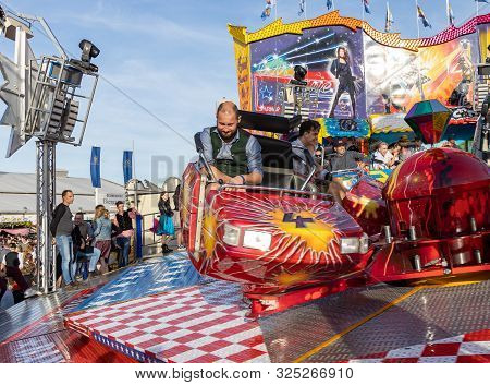 Munich, Germany, 2019 September 28: Visitors Enjoy On An Amusement Park Ride. Breakdancer Fun Ride, 