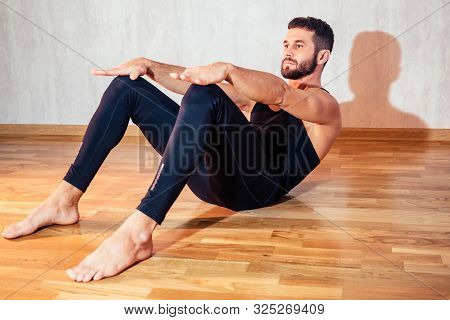 A Muscular Man Does Exercises To Strengthen The Abdominal Muscles On The Floor. Push-up From The Flo