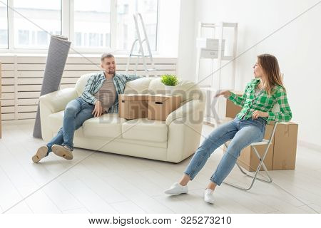 Relocation, Real Estate And Moving Concept - Young Cheerful Couple Moving Into Their New Home