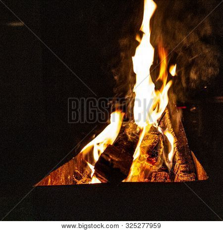 The Fire Burns In The Grill At Night. Bright Fire, Wood. The Flames On The Night