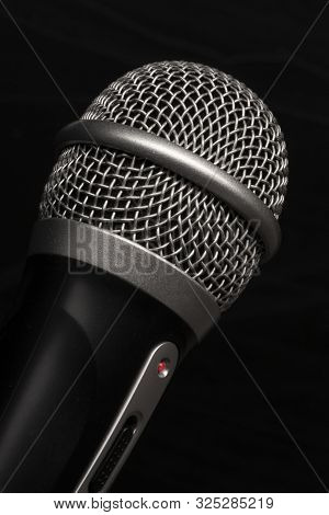 Close-up Black Microphone Head Isolated On Black Background.