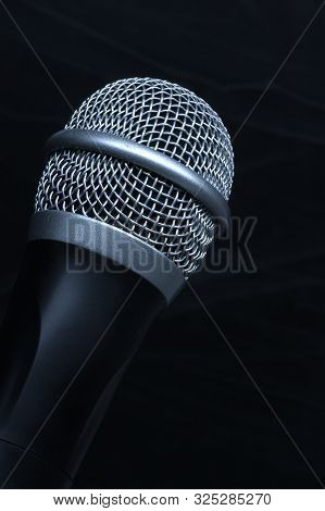 Close-up Black Microphone Head Isolated On Black Background.