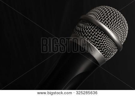 Close-up Black Microphone Head Isolated On Black Background.