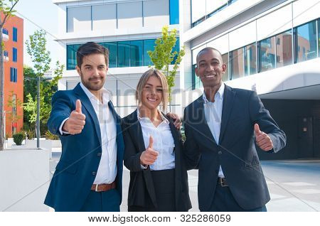 Happy Proud Business Colleagues Making Like Gestures Outside. Business Men And Woman Standing Near O