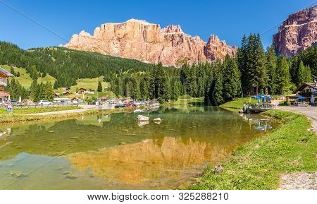 Canazei,italy - September 4,2019 - Pond At The Road To Canazei With Torri Del Sella Mountain In Back