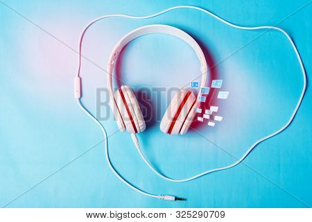 White Red Music Headphones On Technology Background Notbook Computer On A Blue Background. Happy Hol
