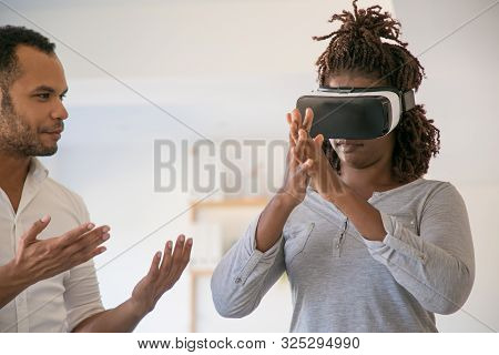 Developer And User Testing Vr Simulator. Man Instructing Female Colleague Wearing Vr Glasses. Virtua