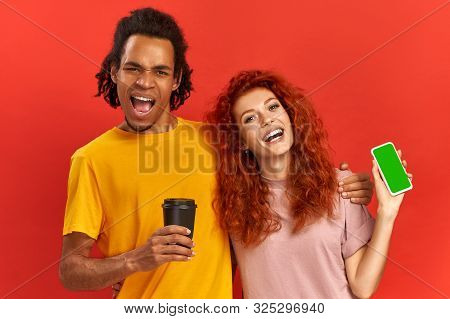 Horizontal View Of Playful Positive Mixed Race Couple Cuddle And Sing Happily, Boost Energy And Mood
