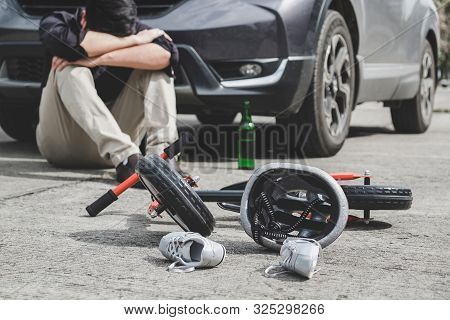 Image Of Shocked And Scared Driver After Accident Involved Kid's Bike And Helmet Lying On The Road O
