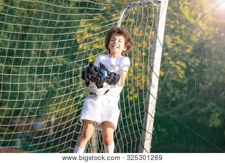 Summer Soccer Tournament For Young Kids. Emotions And Joy Of The Game. Young Goalie. Boy Goalkeeper 