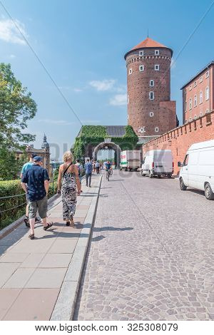 Krakow, Poland - July 26, 2019: People Walking To Gate Of The Bernardines And Sandomierska Tower, Pa