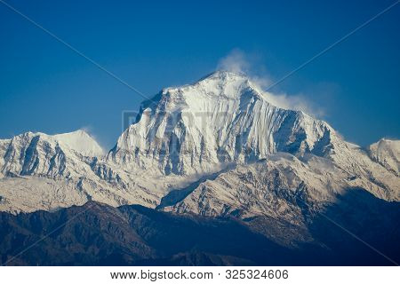 Beautiful View Of The Landscape Of The Himalayan Mountains. Snow-covered Mountain Peaks. Trekking Co