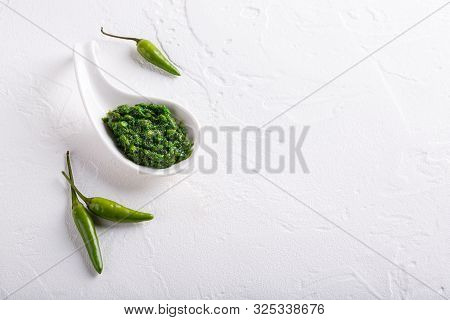 Hot Chili Pepper Paste. Green Sauce On White Background. Adjika Or Ajika In Georgian Cuisine Or Hari
