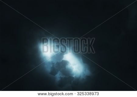 Brightly Sparkling Lightning Breaks Through The Dense Storm Clouds In The Night. Epic Flash Of Light