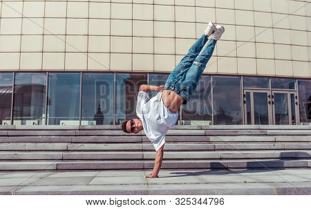 Male Athlete, Guy Dancer Summer City. Stand On One Arm In Air Glasses. Fashionable Modern Break Danc