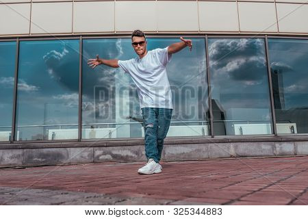 Male Athlete, Guy Dancer Summer City. Background Glass Windows Clouds. Fashionable Modern Break Danc