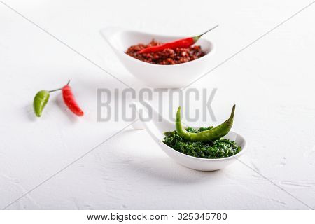 Hot Chili Pepper Paste. Red And Green Sauce On White Background. Adjika Or Ajika In Georgian Cuisine