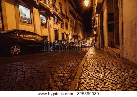 Night Landscape Of Lisbon Street Next To Lisbon Cathedral. View On Rua Da Padaria In Old Part Of Cit