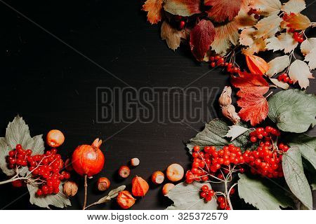 Yellow Autumn Leaves Fruit Pomegranate Nuts On A Black Background